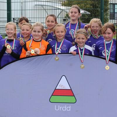 Children from Ysgol Awel y Mynydd with their medals after winning the Urdd Conwy girls’ primary school football tournament