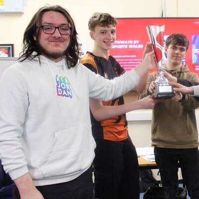 Coleg Llandrillo students with the Valorant Welsh Cup and Esports Wales CEO John Jackson