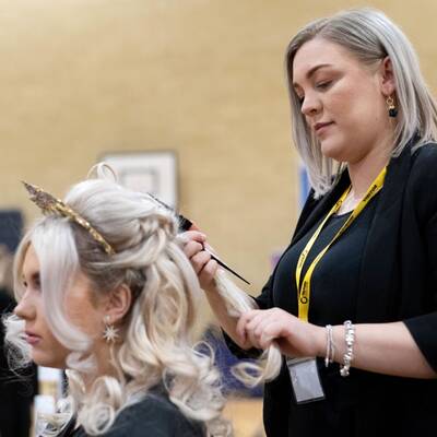 Coleg Llandrillo student Heather Wynne styling hair at the 2024 Concept Hair Learner of the Year final