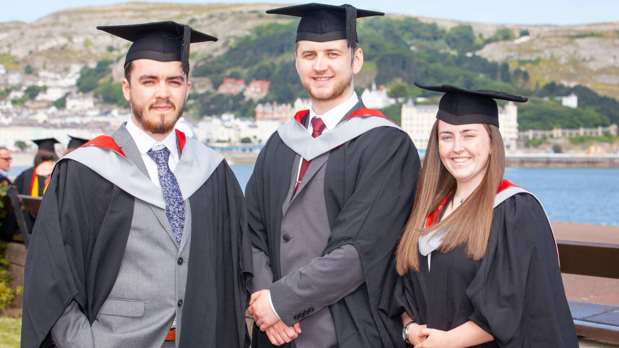 Three higer education learners on graduation day