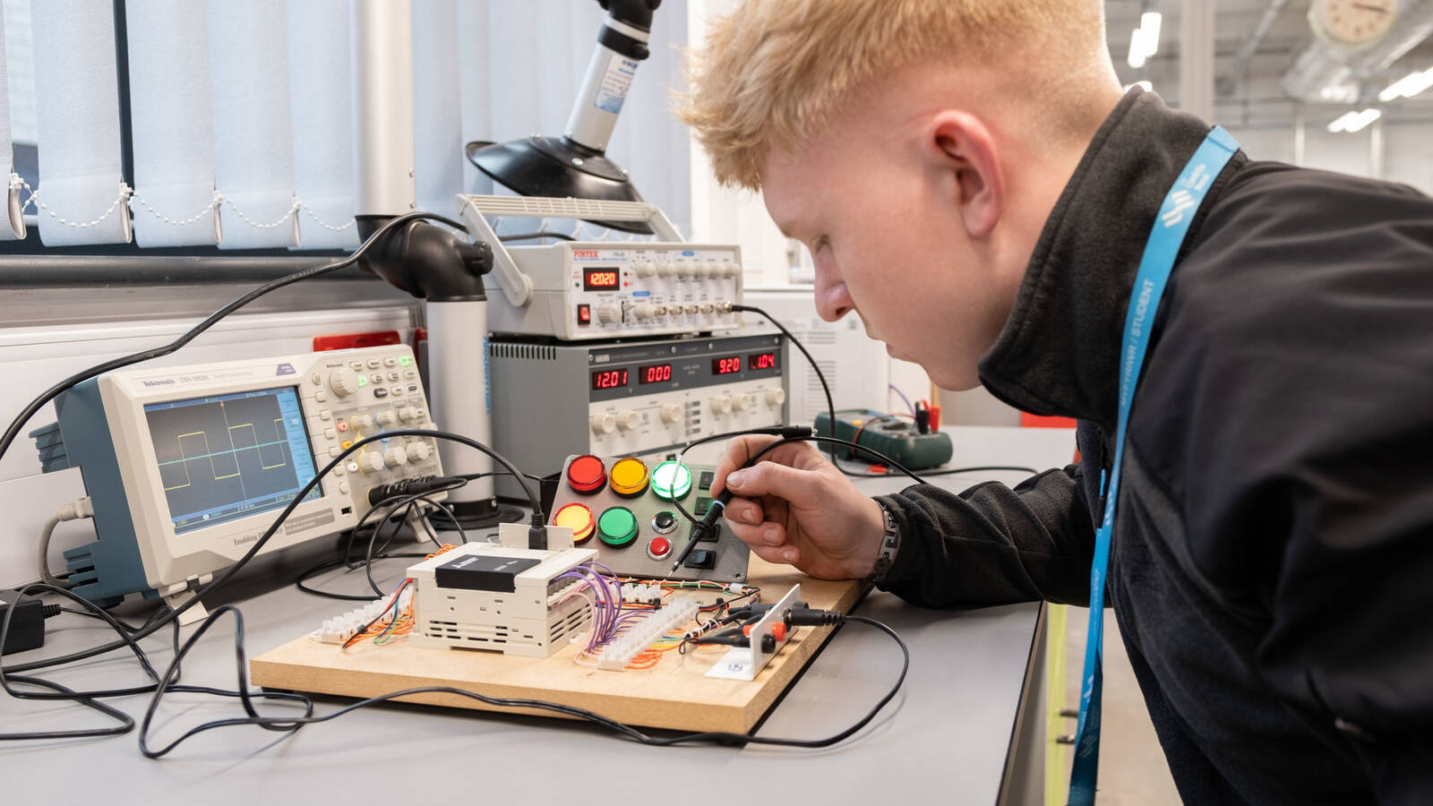 Apprenticeship learner soldering a circuit board in the lab