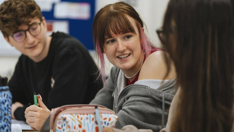 Students talking in a classroom