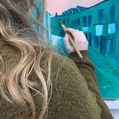 Fine art learner painting a picture for arts exhibition