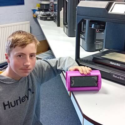 Coleg Meirion-Dwyfor student Daniel Pirie with his mobile phone stand