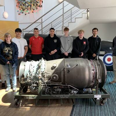 Aeronautical Engineering students with the jet engine at Coleg Menai’s Llangefni campus