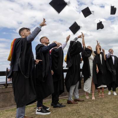 Students celebrate their graduation on the promenade in Llandudno