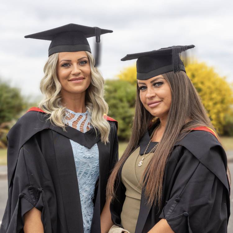 Sisters Kelly and Sarah Kynaston at the Grŵp Llandrillo Menai graduation ceremony at Venue CymruCymru