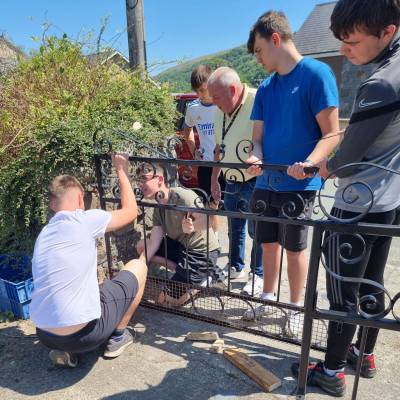 Students installing the gate with Gwyn Williams watching