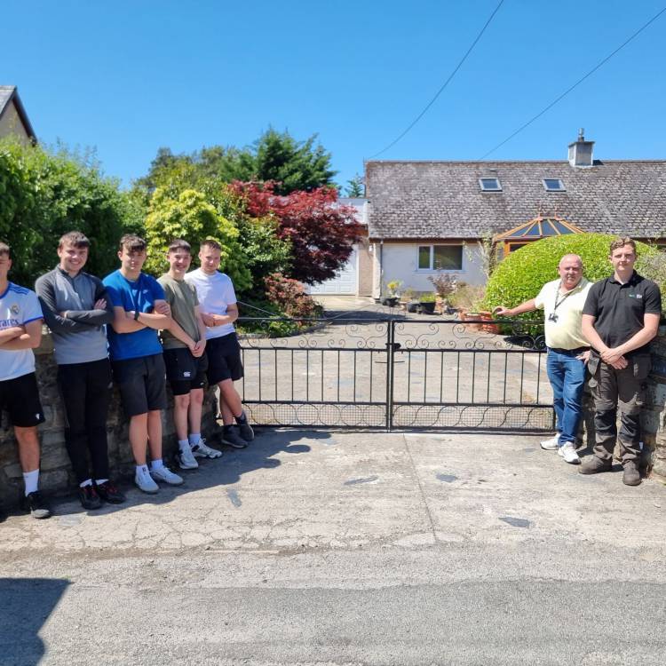 Students Cian Pritchard, Kevin Evans, Caio Morgan, Cian Jones and Huw Jones and tutors Gwyn Williams and Tom Allday with the gate