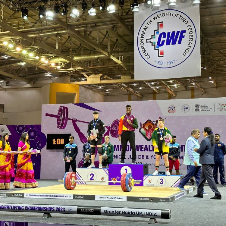 Cian Green on the podium after winning the silver medal in the Commonwealth Weightlifting Championships