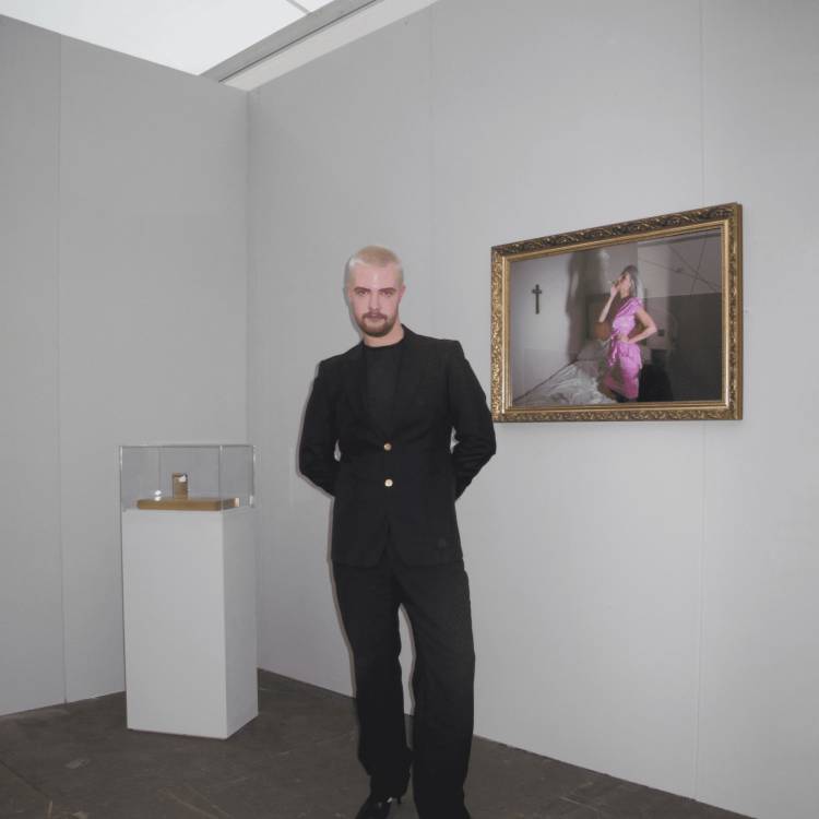 Llyr Evans with one of his portraits