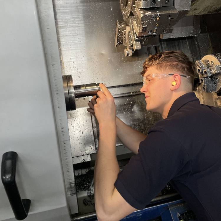 Osian Roberts working as a CNC turning centre operator for IAQ