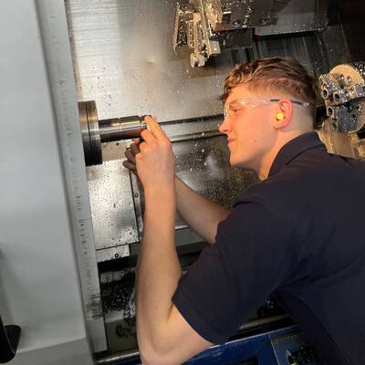 Osian Roberts working as a CNC turning centre operator for IAQ