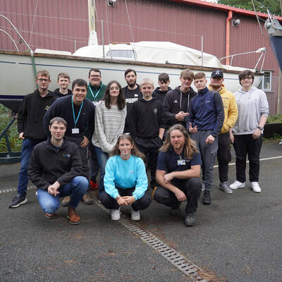 Lois Roberts with marine engineering students and lecturers at Coleg Meirion-Dwyfor’s Hafan campus in Pwllheli