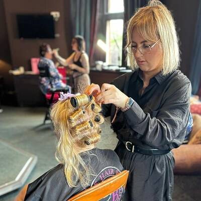 Elle Maguire cutting a client’s hair at her salon, The Hair Bar in Bangor