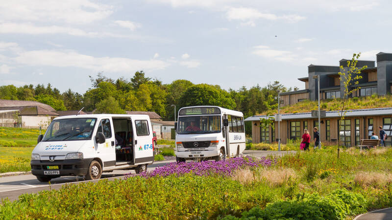 Mini bus and bus outside Glynllifon campus