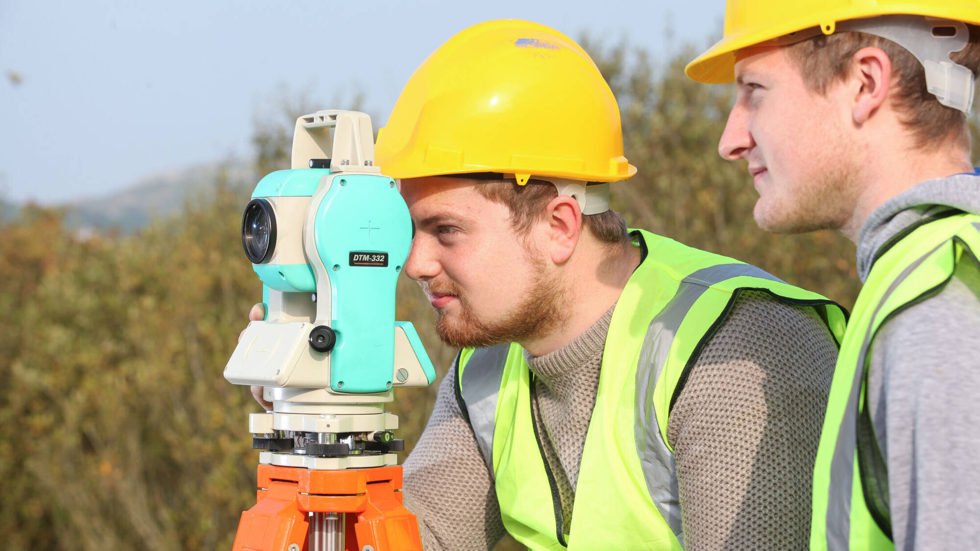 Students looking through a total station