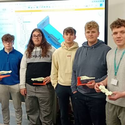 Coleg Meirion-Dwyfor students with their F1 in Schools designs at Coleg Menai’s engineering centre in Llangefni