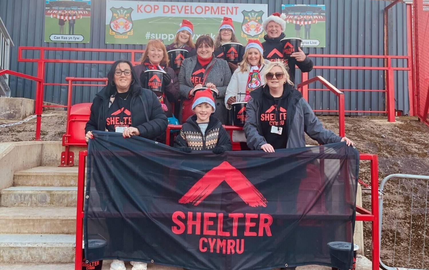 Shelter Cymru volunteers outside The Racecourse Ground in Wrexham