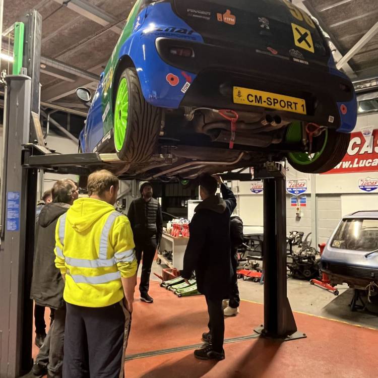 People working on the Menai Motorsports car as part of the Basic Car Maintenance course offered by Multiply at Coleg Menai in Llangefni