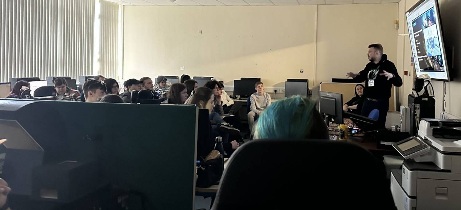 A games developer talking to Coleg Llandrillo students