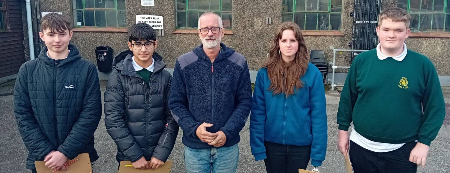 High-school students with export manager Chris Rowlands at the DMM factory in Llanberis