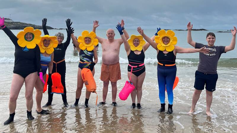 People on the beach at Trearddur Bay after enjoying a wild-water swim as part of a Multiply session
