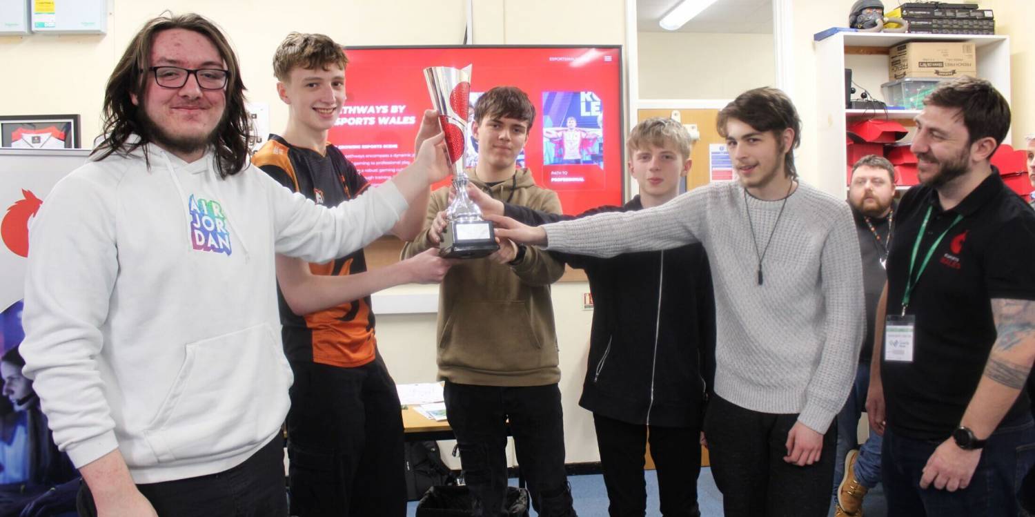 Coleg Llandrillo students with the Valorant Welsh Cup and Esports Wales CEO John Jackson