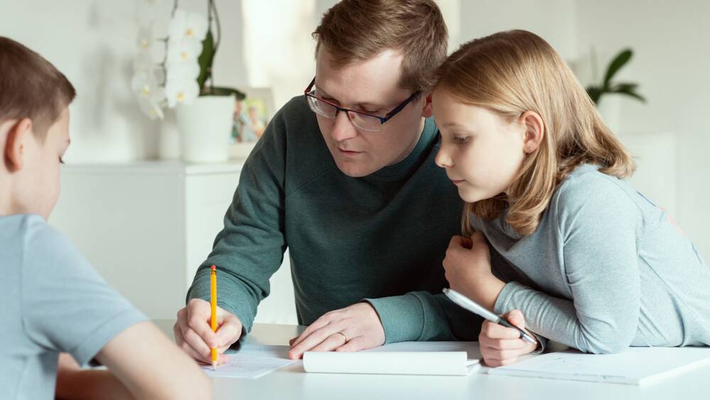 Parent helping child with homework