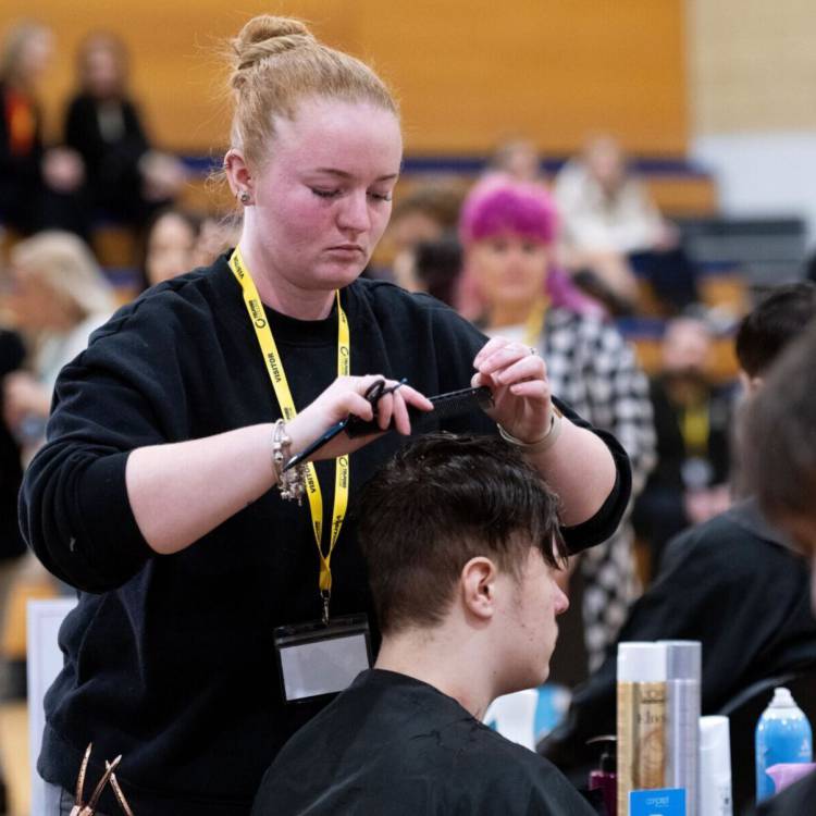 Coleg Llandrillo student Leah Oldham styling hair at the 2024 Concept Hair Learner of the Year final