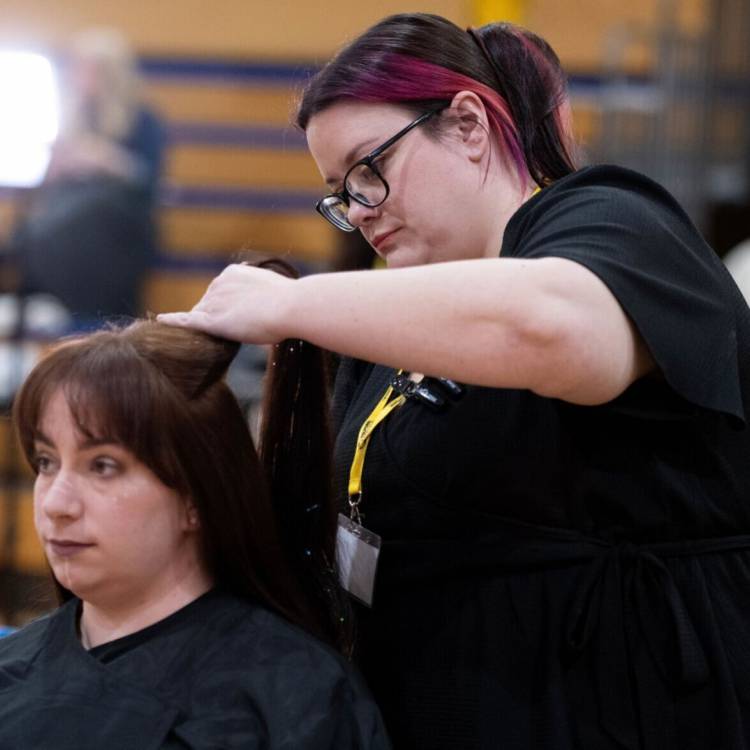 Coleg Llandrillo student Ceri Thomas styling hair at the 2024 Concept Hair Learner of the Year final