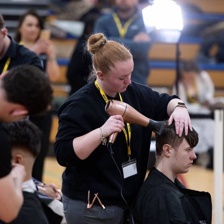 Coleg Llandrillo student Leah Oldham styling hair at the 2024 Concept Hair Learner of the Year final