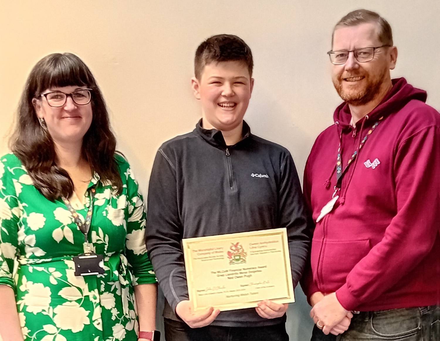 Fflur Rees Jones, Ned Pugh with the WLCOW Financial Numeracy Improvement Award, and Emlyn Evans
