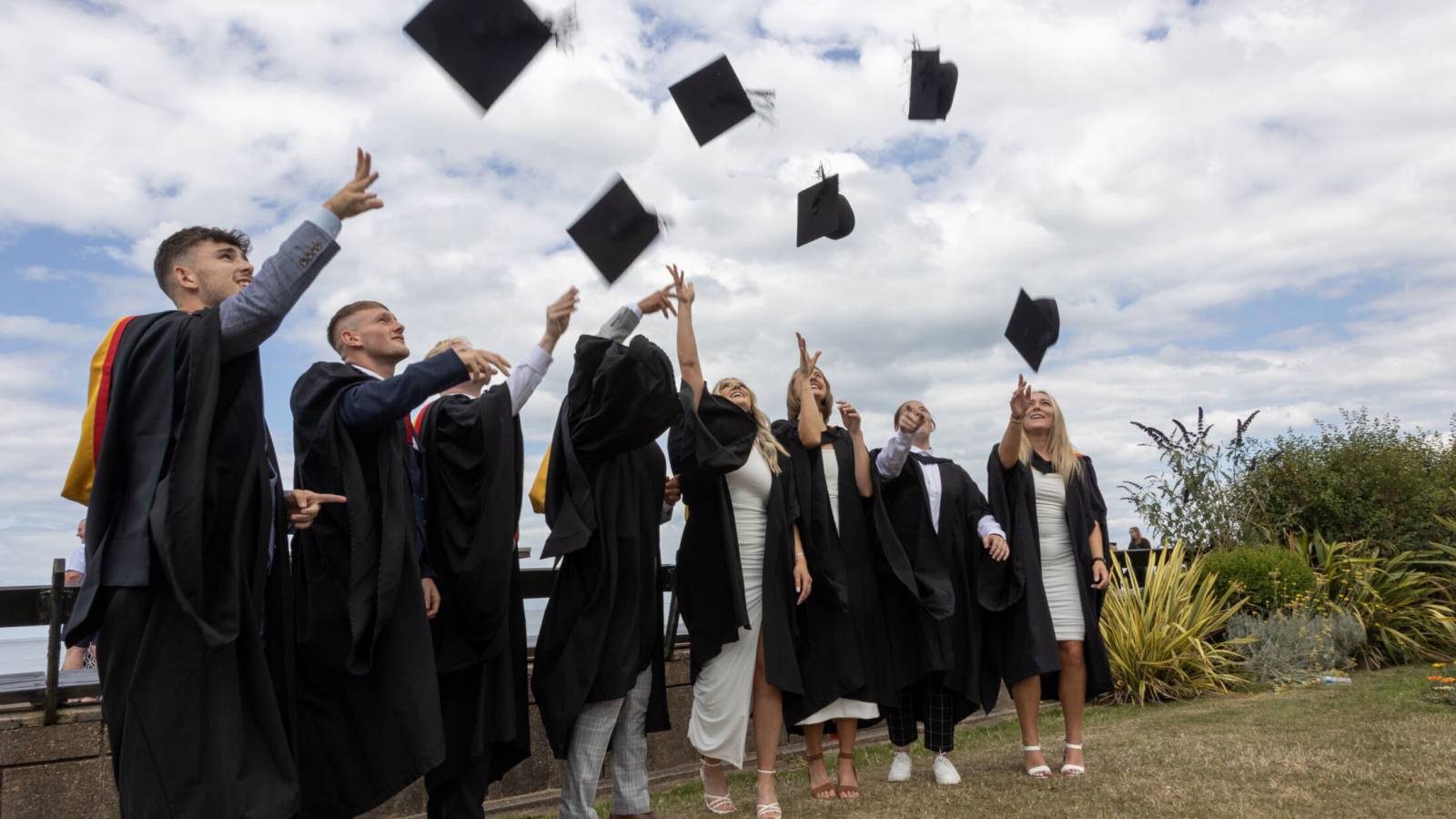 Graduates celebrating on the Promenade in Llandudno