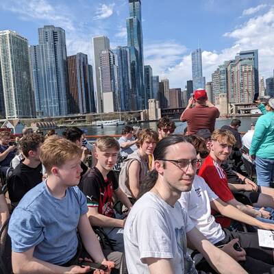 Coleg Menai students on a boat tour of Chicago with skyscrapers in the background