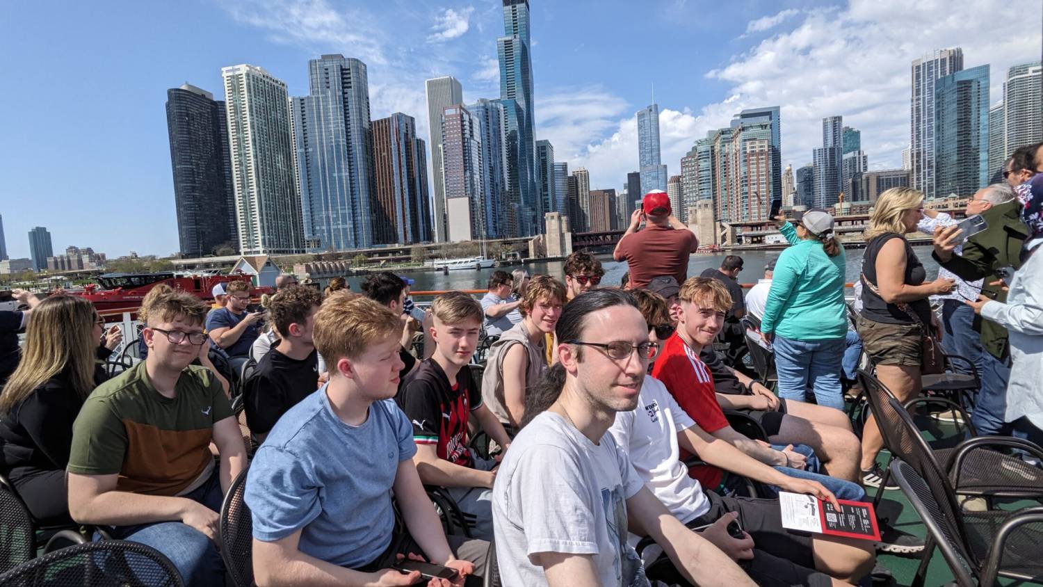 Coleg Menai students on a boat tour of Chicago with skyscrapers in the background