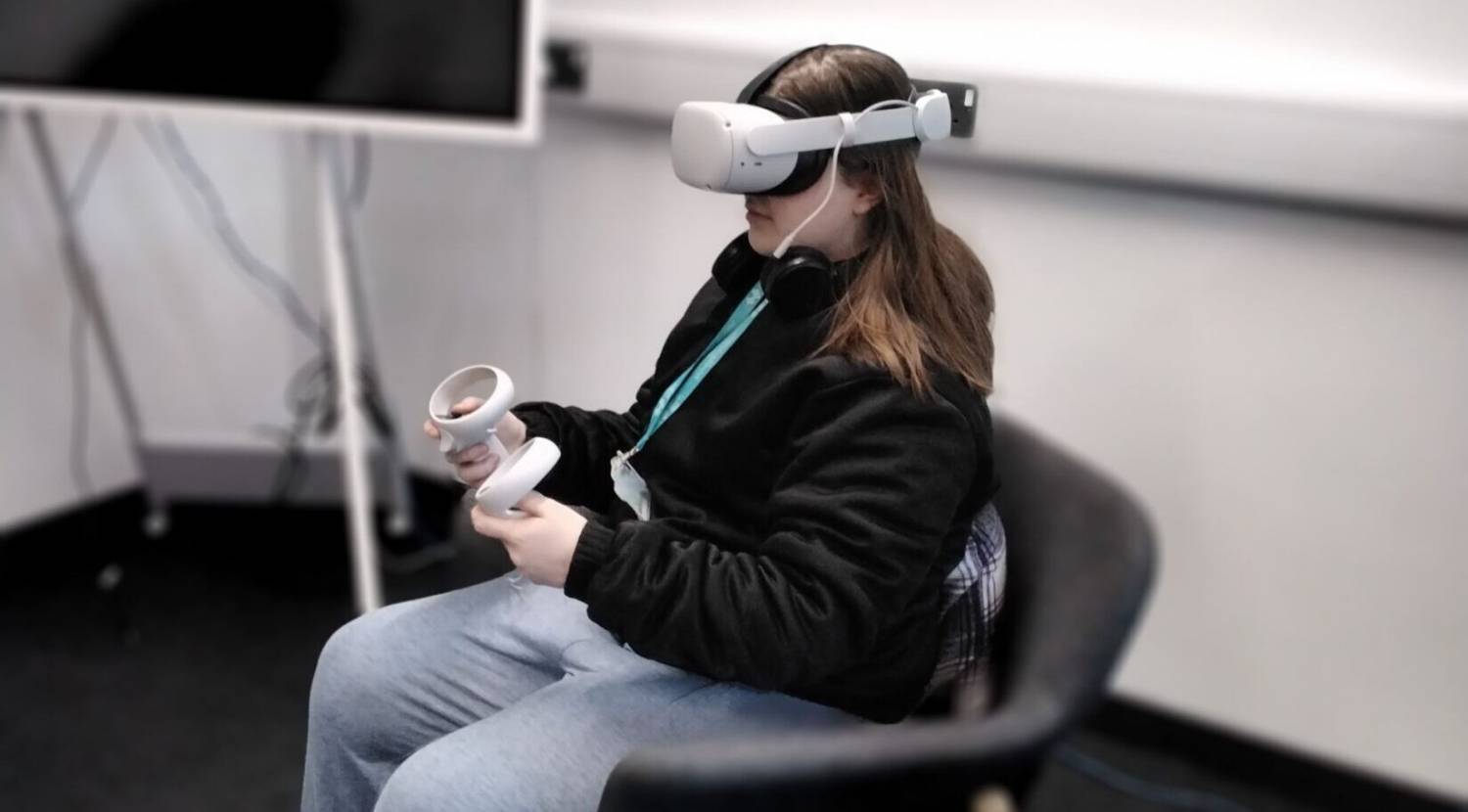 A Coleg Meirion-Dwyfor learner using a virtual reality headset at M-SParc in Gaerwen