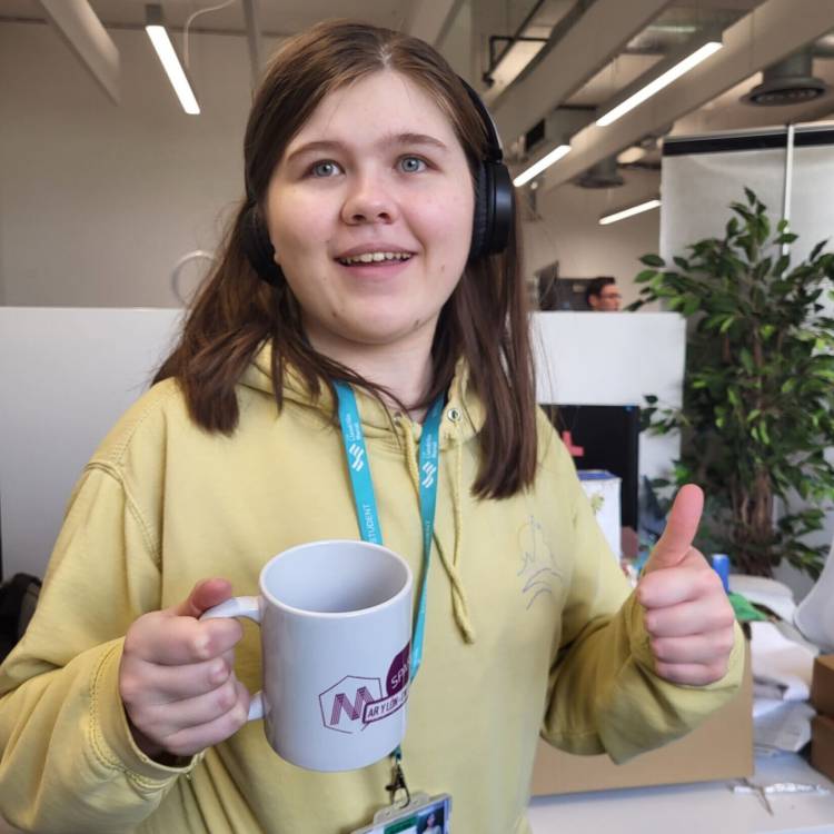 A Coleg Meirion-Dwyfor learner with her custom-design mug at M-SParc in Gaerwen