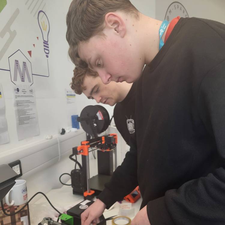 Coleg Meirion-Dwyfor learners adding custom designs to mugs at M-SParc in Gaerwen