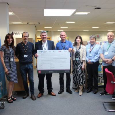 Grŵp Llandrillo Menai CEO Dafydd Evans, union representatives and TUC organising development officer Kevin Williams with the Charter