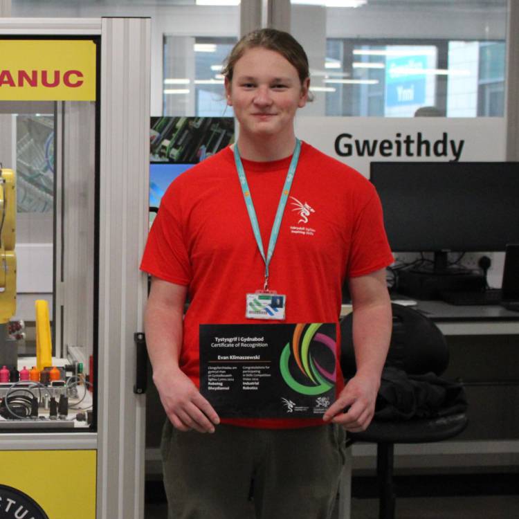Coleg Menai student Evan Klimaszewski with his certificate after competing in Skills Competition Wales 2024