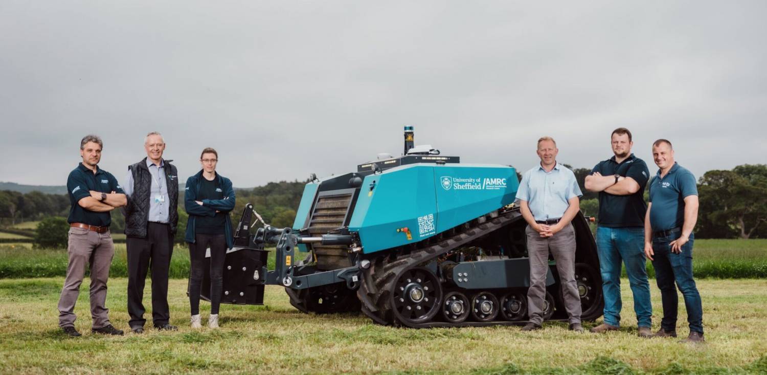 Staff from AMRC Cymru and Coleg Glynllifon with the AgBot on the Tyn Rhos field at Coleg Glynllifon’s farm
