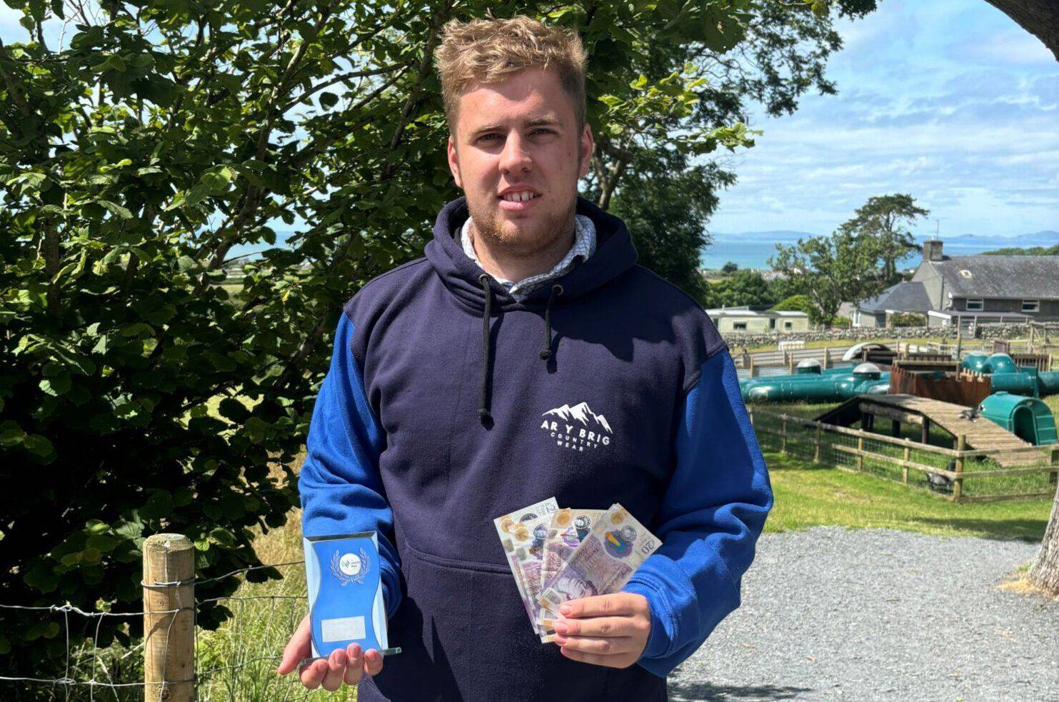 Euron Jones with his trophy and cash prize after winning Grŵp Llandrillo Menai’s Entrepreneur of the Year Award