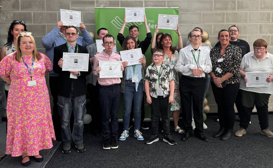 Learners celebrating at Coleg Menai in Llangefni after completing their Project SEARCH internships