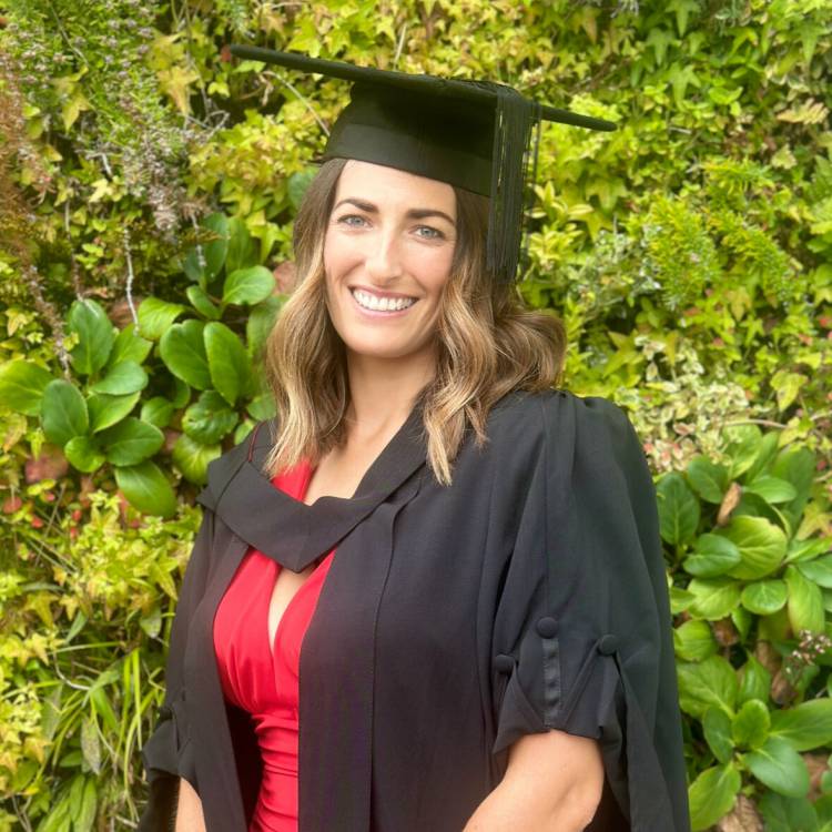 Jaimee Wellings in her graduation cap and gown after completing her PGCE