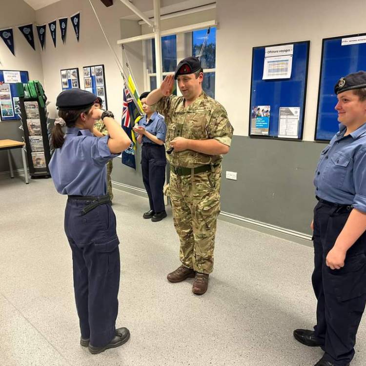 Coleg Menai student Katie Jones being presented with her 1st class badge in marine engineering at Sea Cadets