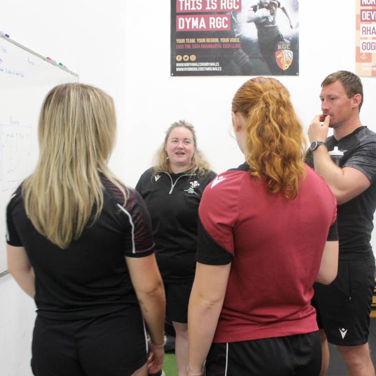 Leah Stewart and Begw Ffransis Roberts talking to rugby academy assistant coach Lucy Brown and academy co-ordinator Andrew Williams
