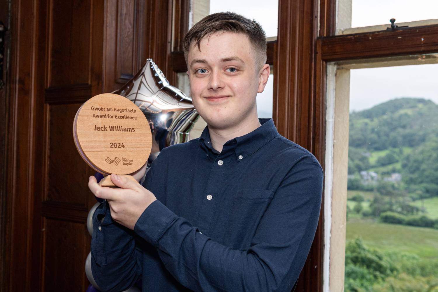 Jack Williams holding his Award for Excellence at Coleg Meirion-Dwyfor’s annual Achievers Awards 2024