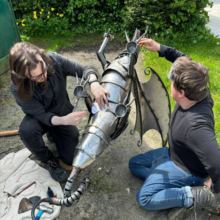 Coleg Menai students Cai Roberts (left) and Harry Vanmaele working on a steel dragon