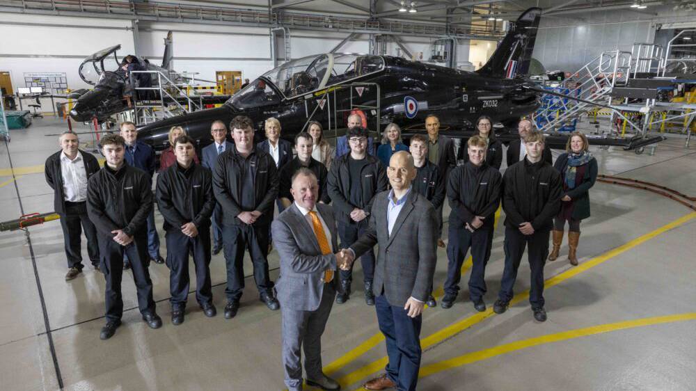 Staff from Babcock and Grŵp Llandrillo Menai photographed with a Hawk Aircraft